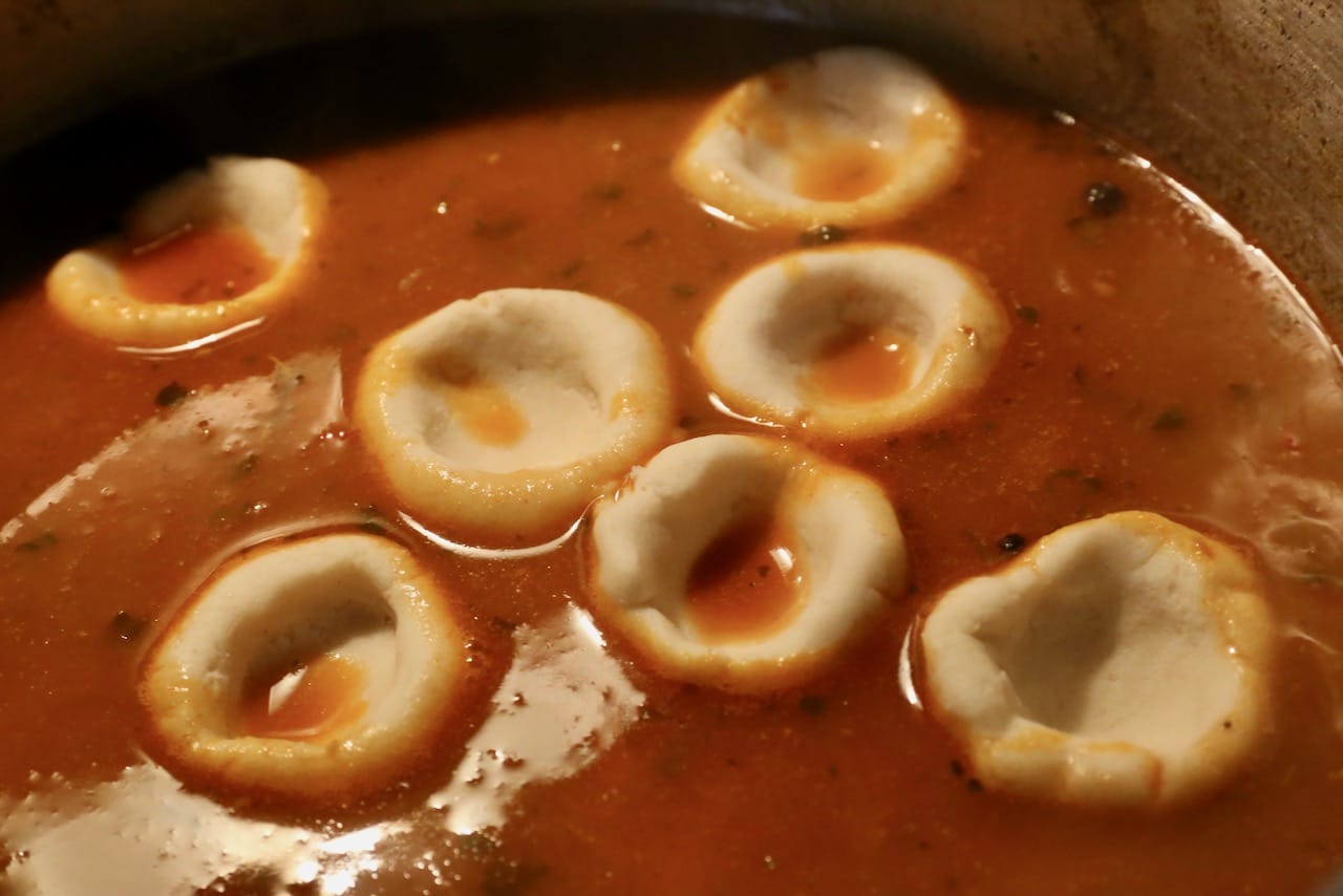 Simmer masa dumplings in soup broth until tender. 