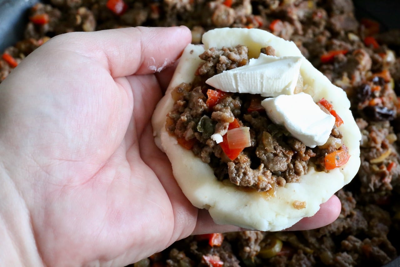These Caribbean fritters have a mashed potato exterior and ground meat interior.