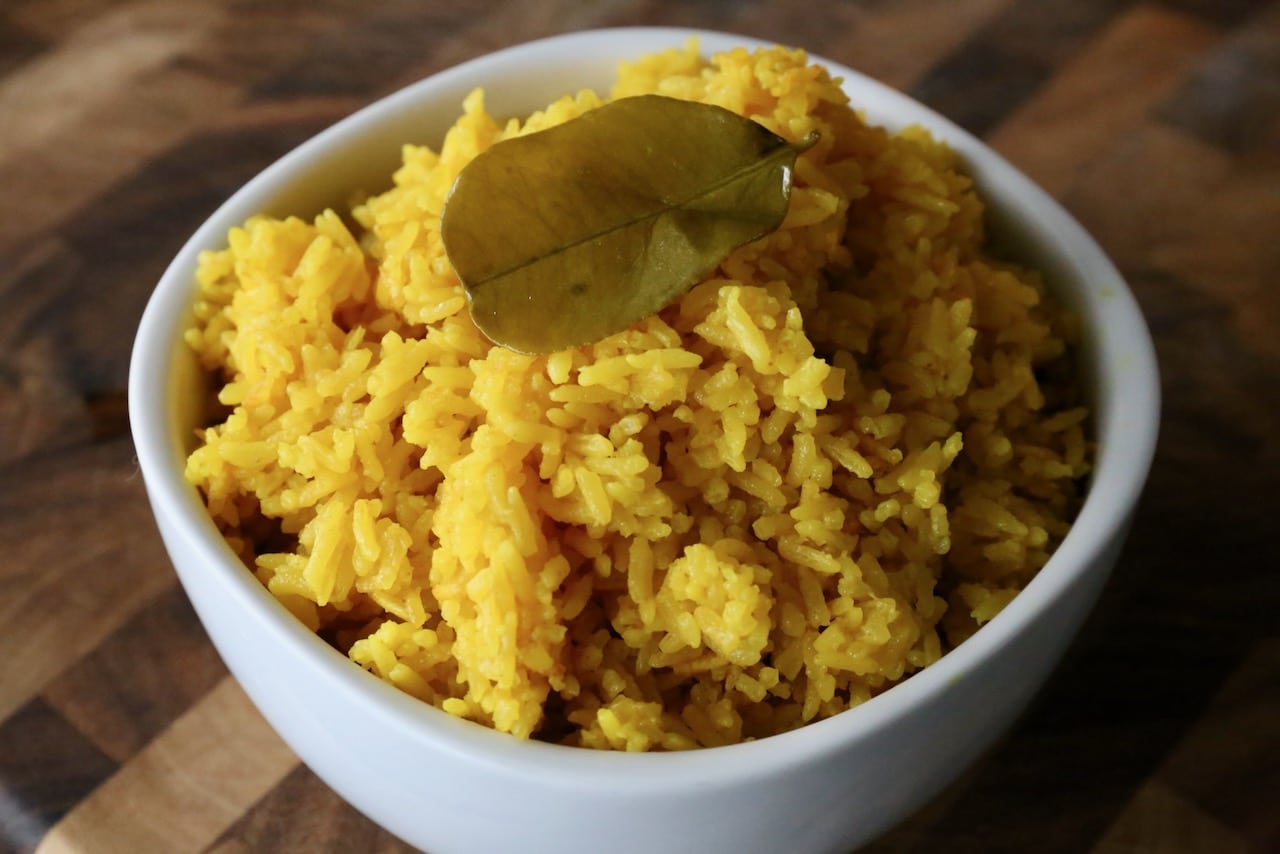 Garnish Indonesian Yellow Rice with lime leaf.