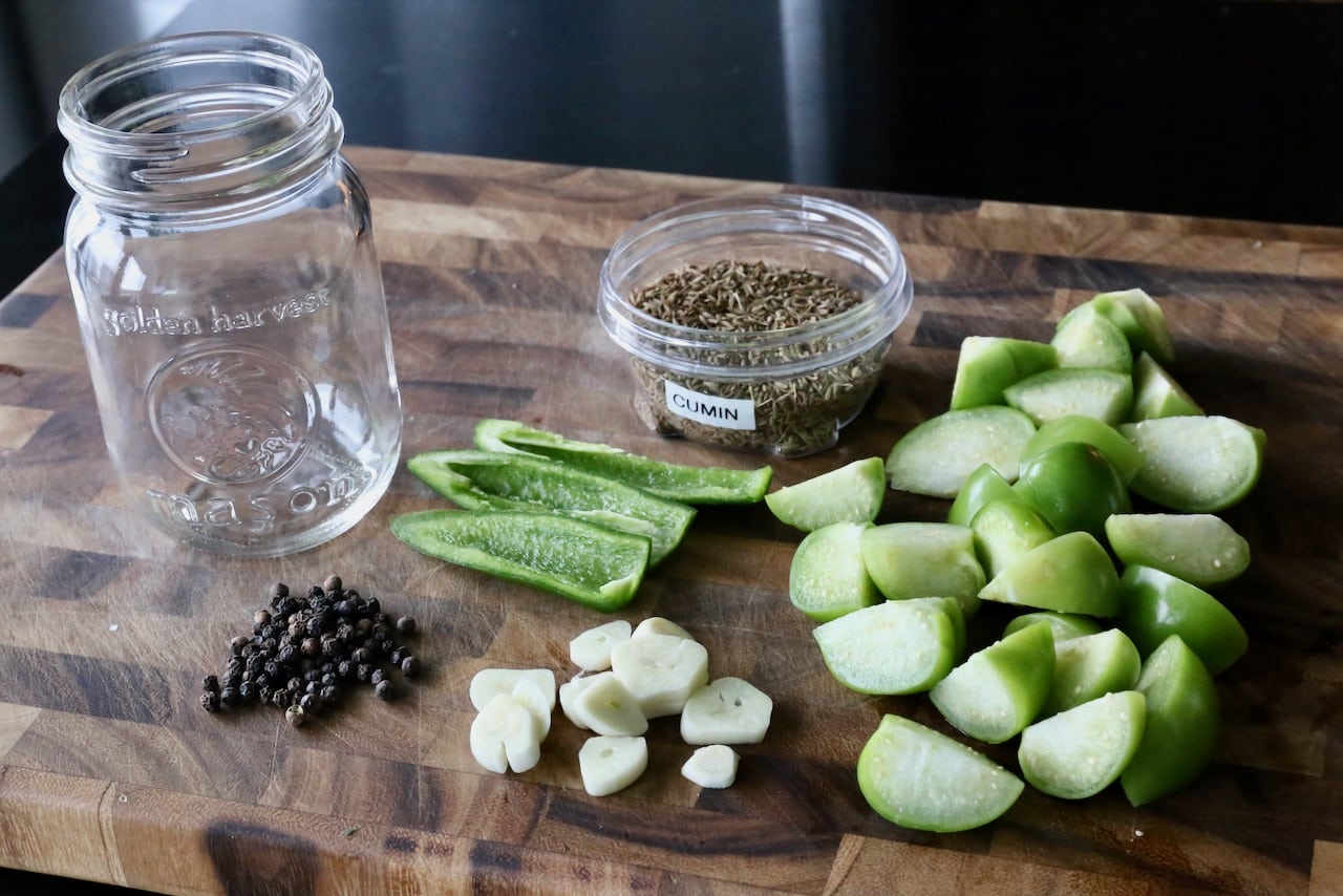 Prepare pickles by slicing the tomatillos, garlic and jalapeno.