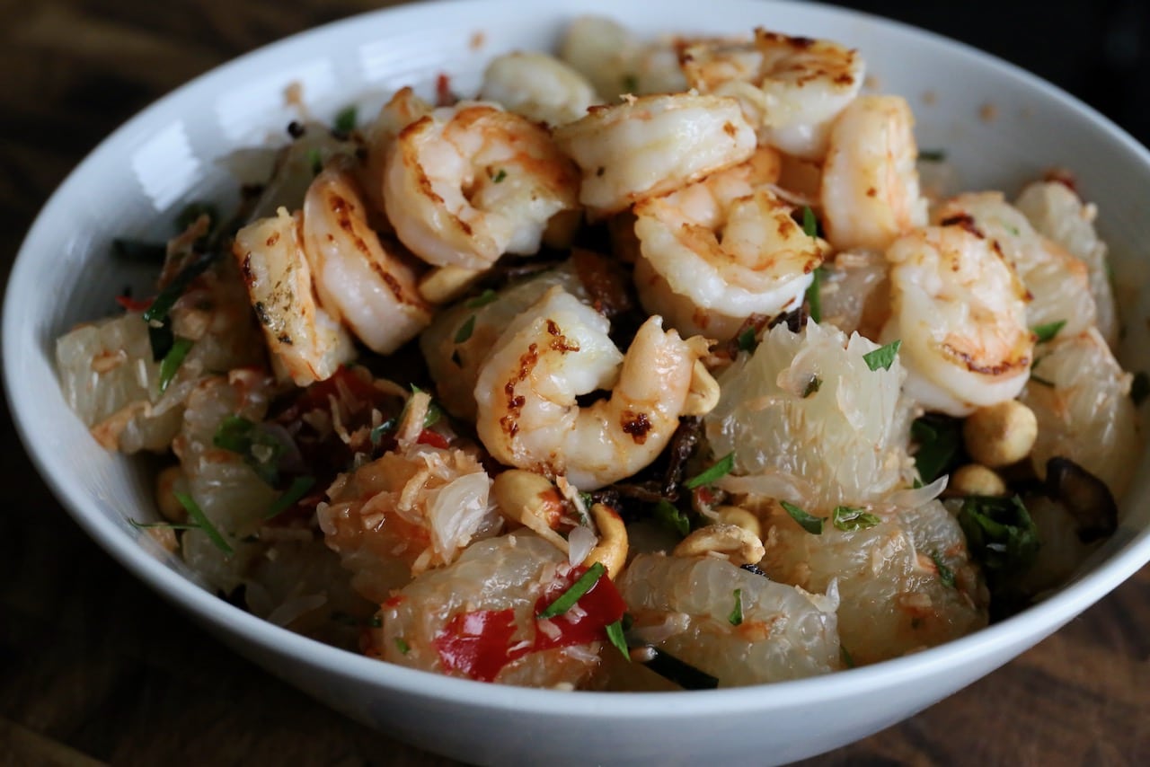 Thai Pomelo Salad is typically served with seafood like shrimp or crab. 