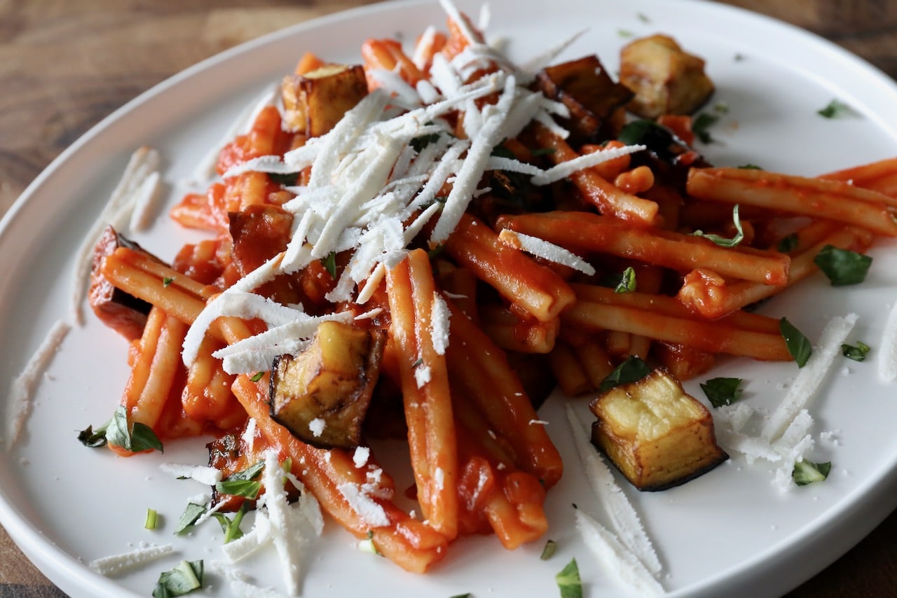 Serve Casarecce alla Norma with grated ricotta salata cheese.
