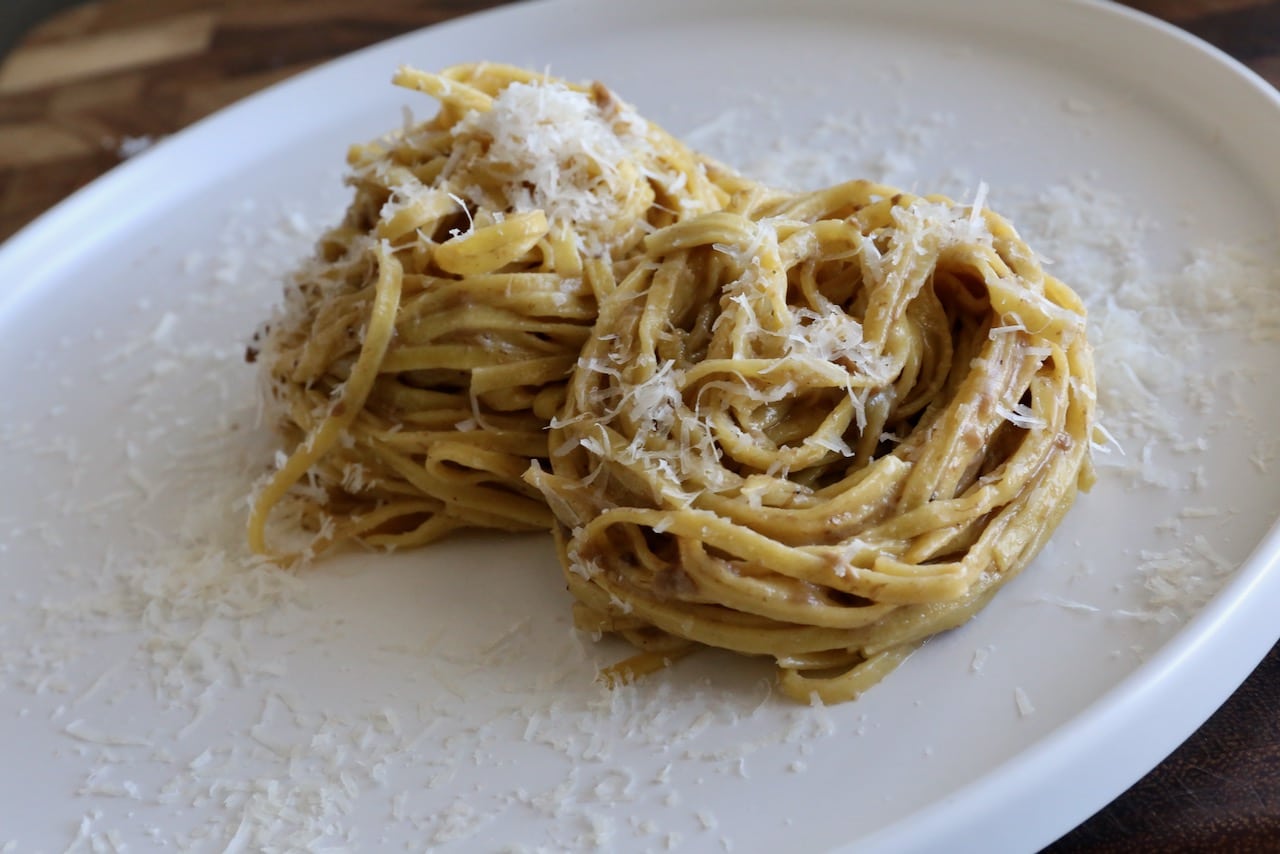 Serve Tajarin Pasta sprinkled with grated parmesan cheese.