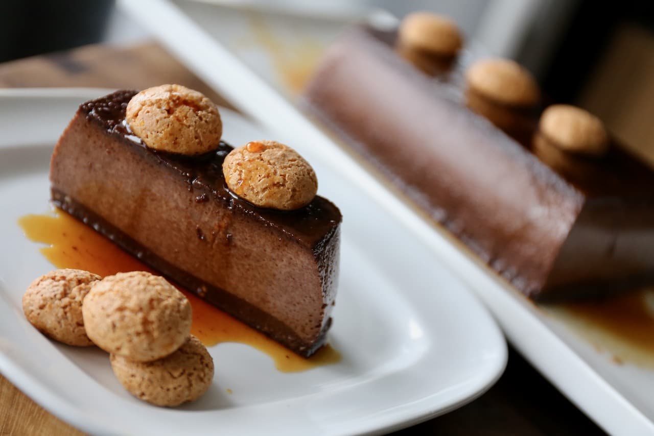 Serve slices of Bonet alla Piemontese for dessert with amaretti cookies and espresso coffee.