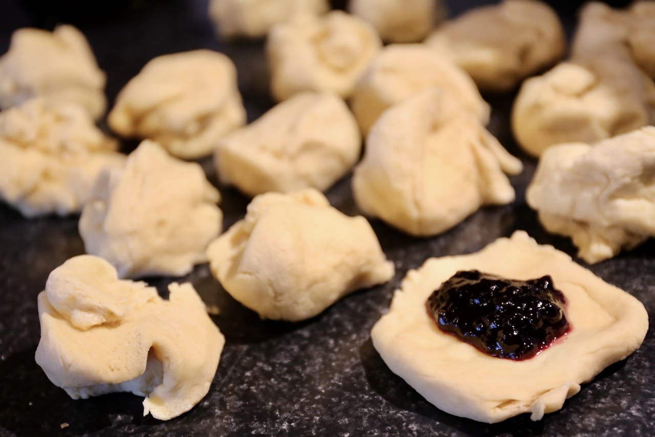 Fill each flattened piece of dough with a dollop of your favourite jam.