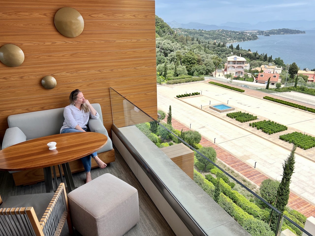 Chic suite balconies offer beautiful views overlooking the Ionian Sea at Angsana Hotel Corfu.