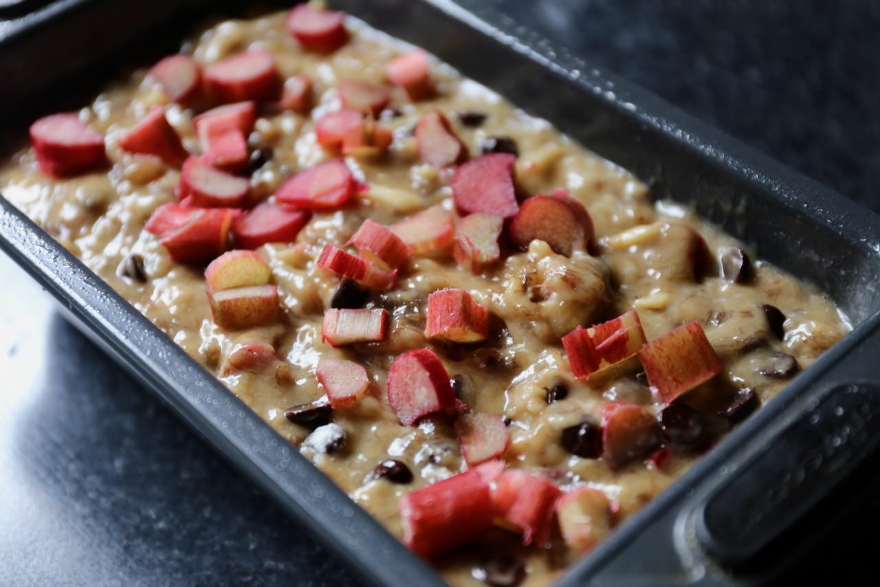 Pour bread batter into bread pan and top then sprinkle with chopped rhubarb before baking.