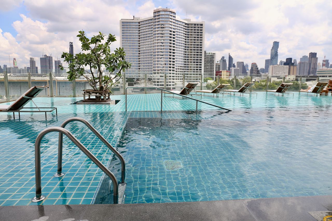 Millennium Hilton Bangkok Hotel Rooftop Pool overlooks the Chao Phraya River.