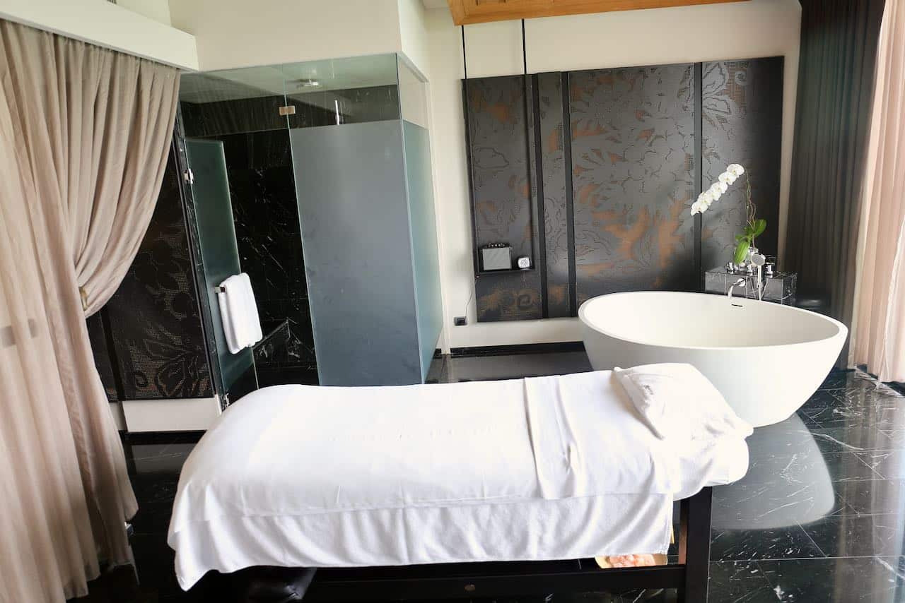 A chic treatment room at SO/ Spa in Bangkok features an oversized bathtub. 