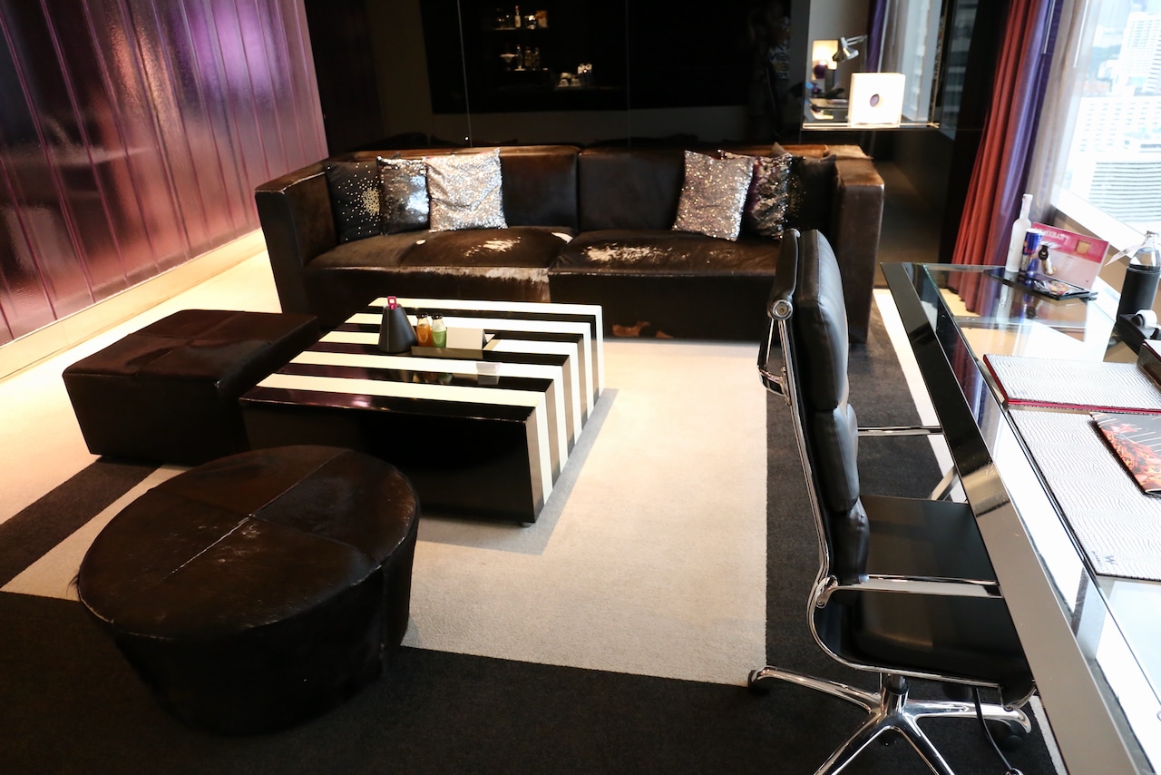 Work desk and living room area at W Bangkok's spacious Marvelous Suite. 