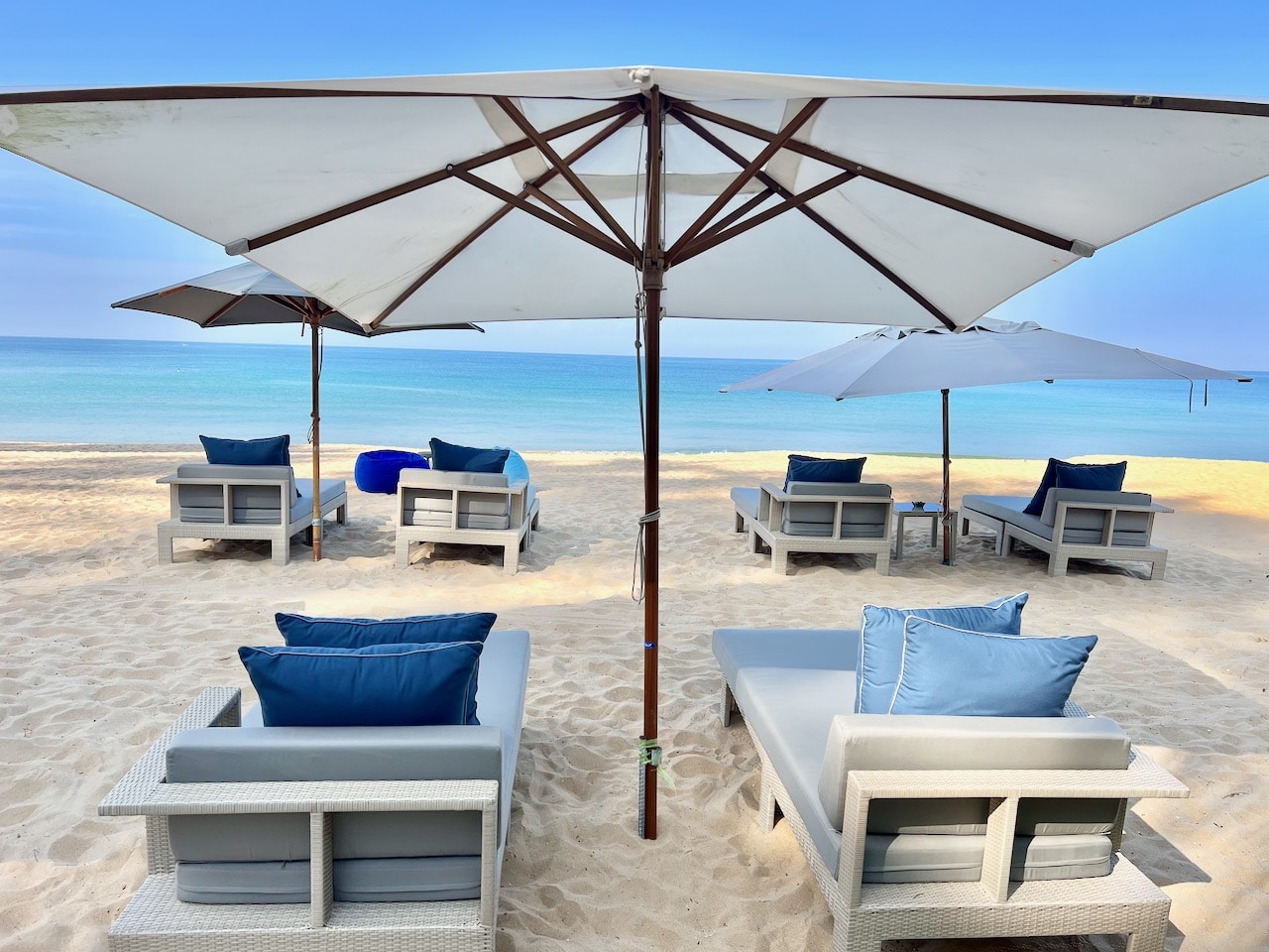 Aleenta Phuket Resort sits on a soft sandy beach and features plush loungers with umbrellas.