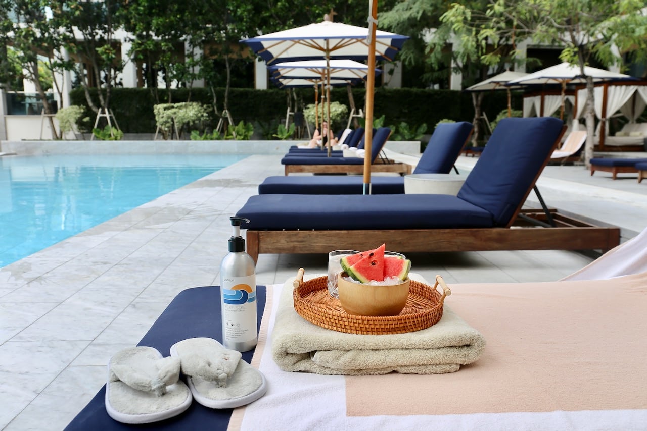 Attendants at Capella Bangkok serve complimentary watermelon slices on ice while you relax in a lounger.