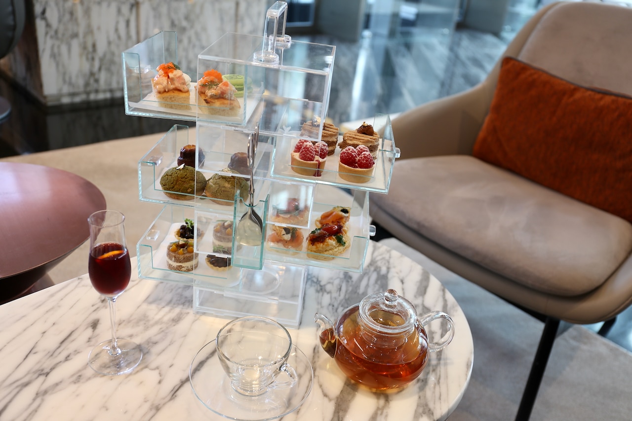 Le Méridien Bangkok Hotel serves its high tea out of a transparent case that is accessed by sliding drawers.
