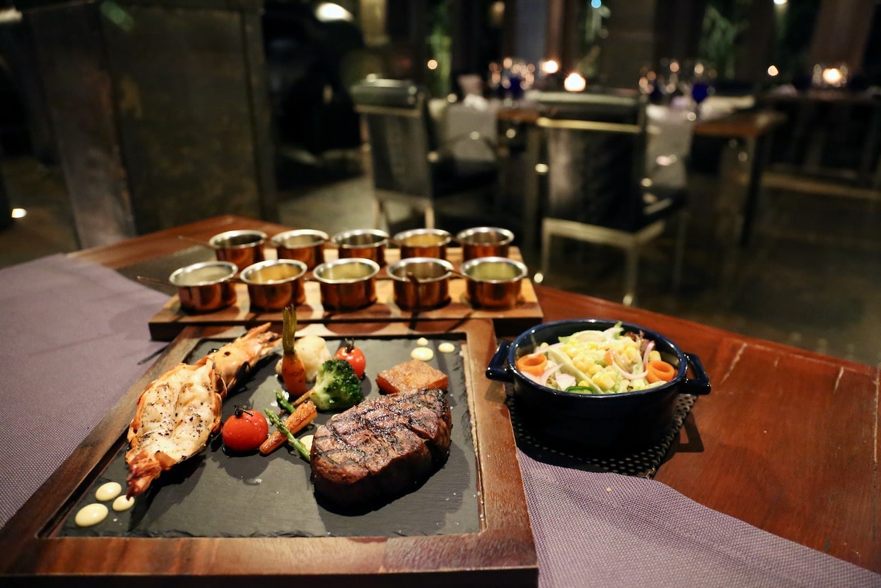 We recommend ordering the surf & turf at Rivet & Rebar, featuring Phuket grilled prawn and mouth-watering beef tenderloin. 