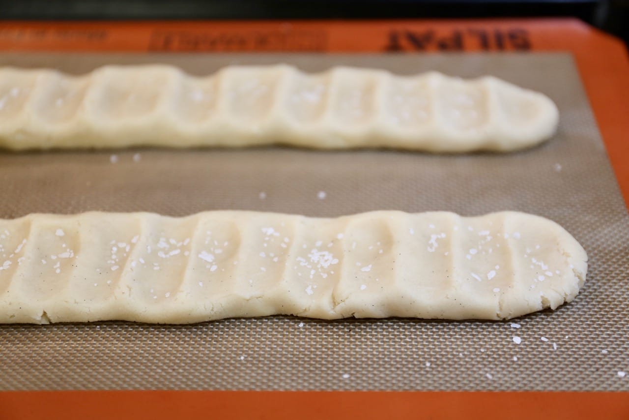 Press down on the cookie dough lightly with your fingers before baking.