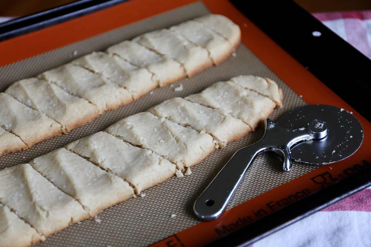 Use a pizza cutter to make "caramel cuts" immediately after the cookies come out of the oven.
