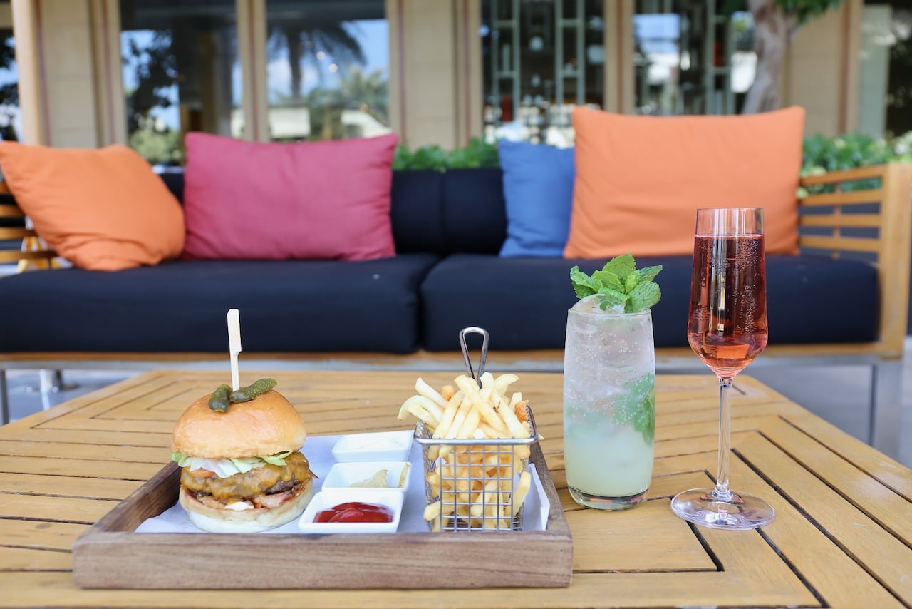 Enjoy a juicy burger paired with craft cocktails at the Le Méridien Suvarnabhumi pool. 