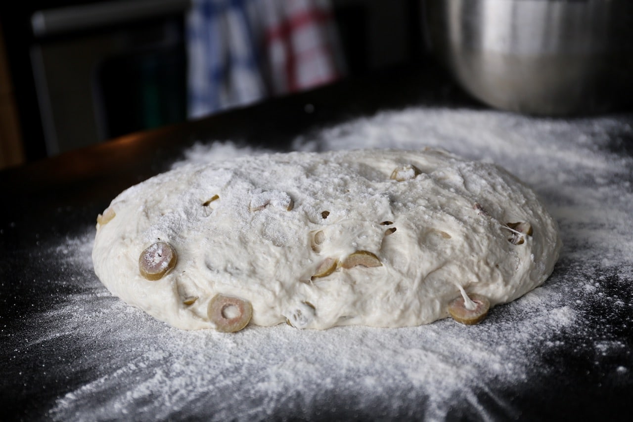 Tip Olive Ciabatta dough onto a floured surface. 