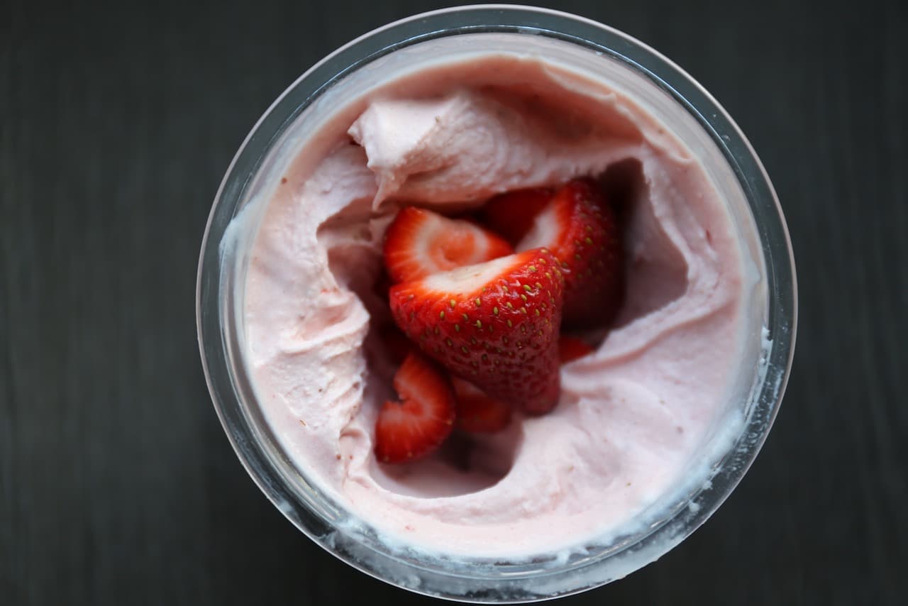Using the Ninja Creami mix in feature blend the fresh strawberries into into the ice cream base.