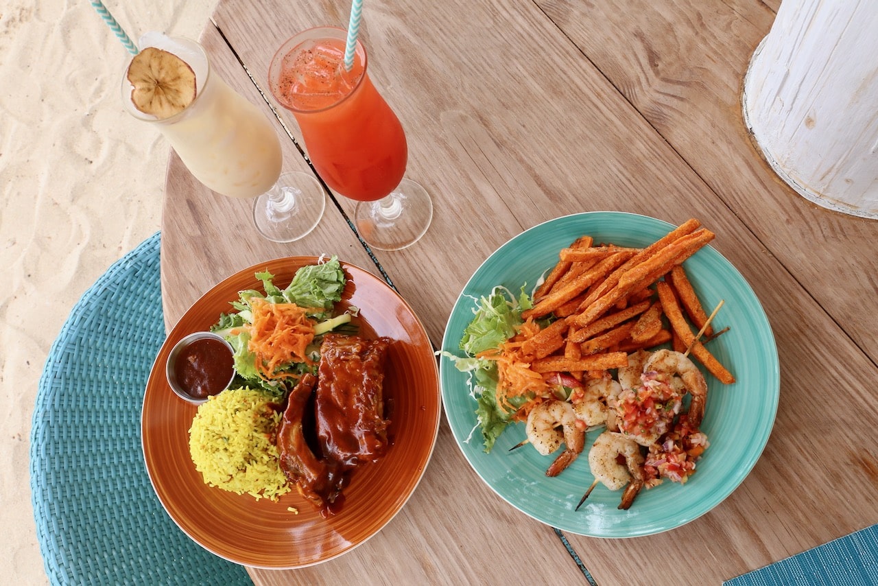 Enjoy tropical cocktails and barbecue favourites like pork ribs and shrimp skewers during lunch at Beach Cabana.