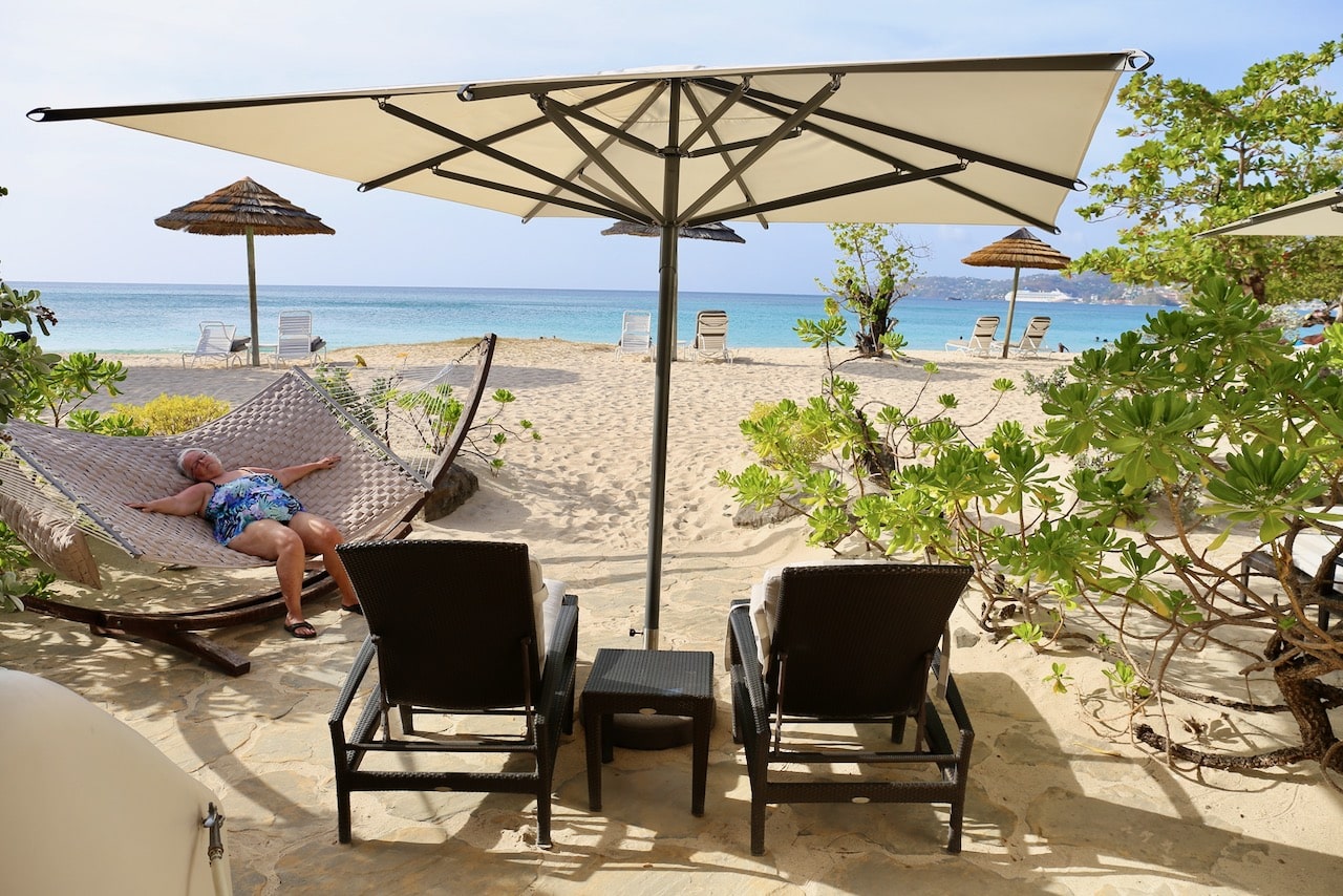 Seagrape Beach Suites feature backyard patios outfitted with lounge chairs and hammock. 