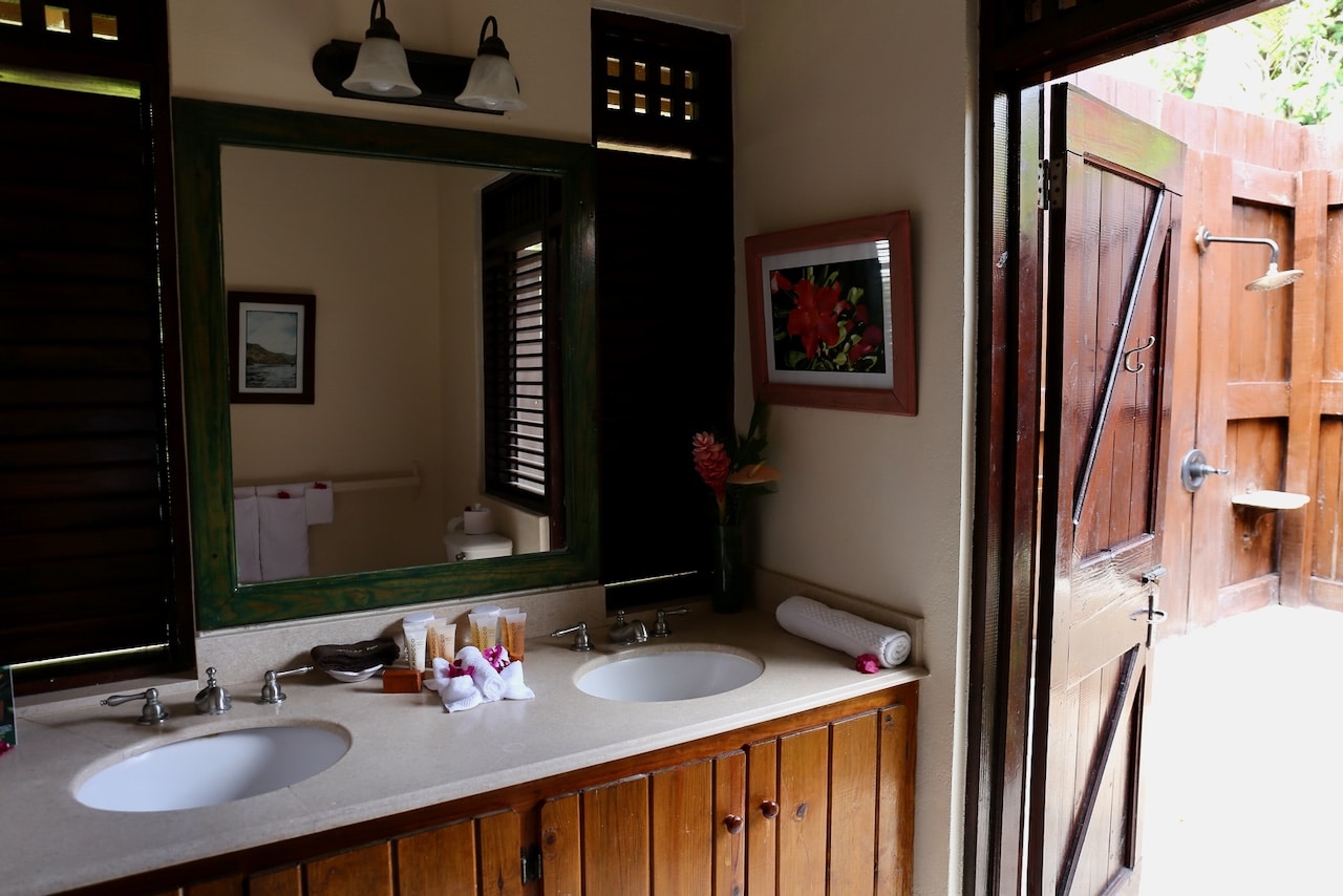 Villa bathrooms feature an indoor toilet and sink, plus romantic outdoor rain shower. 