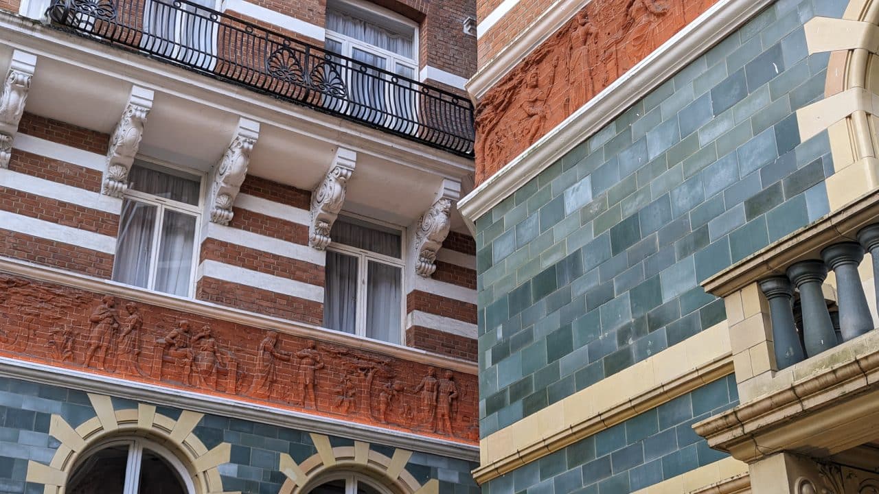 The Shakespearean frieze encircling the green-tiled courtyard at St. James’ Hotel in London.