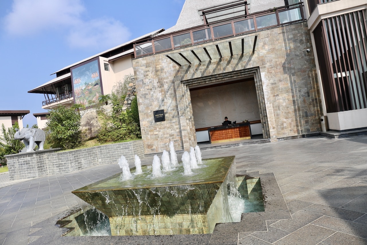 The Dusit Thani Himalayan Resort's entrance includes a water feature, elephant statue and Buddhist mural. 