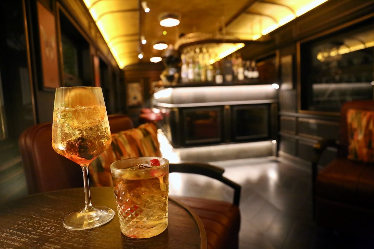 Enjoy cocktails in a vintage train car at Papillon Bar.