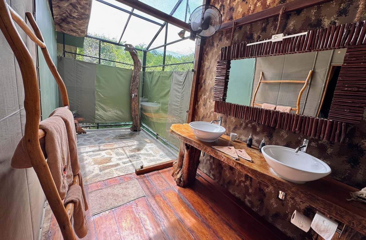 Glamping accommodation features chic outdoor showers. 