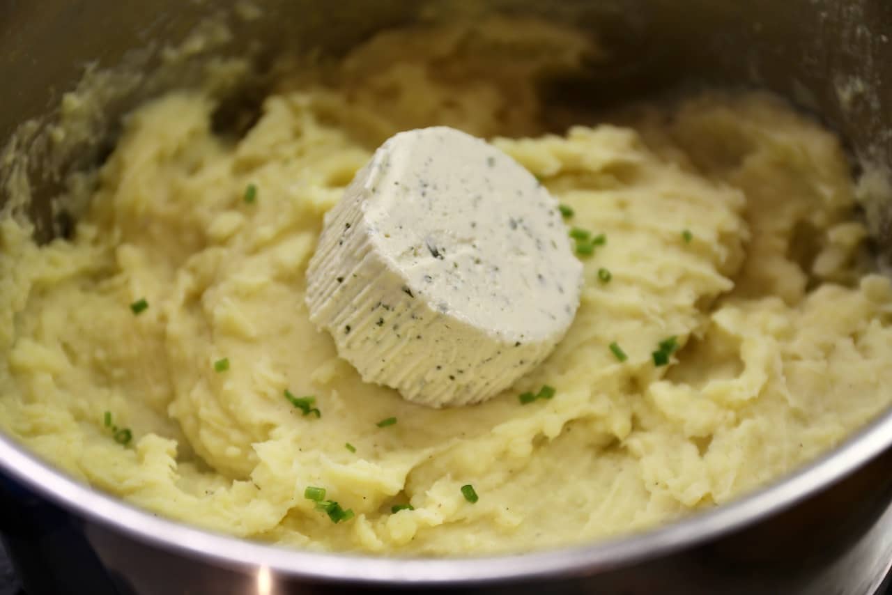Add an entire wheel of Garlic Boursin French Cream Cheese to the mashed potatoes.