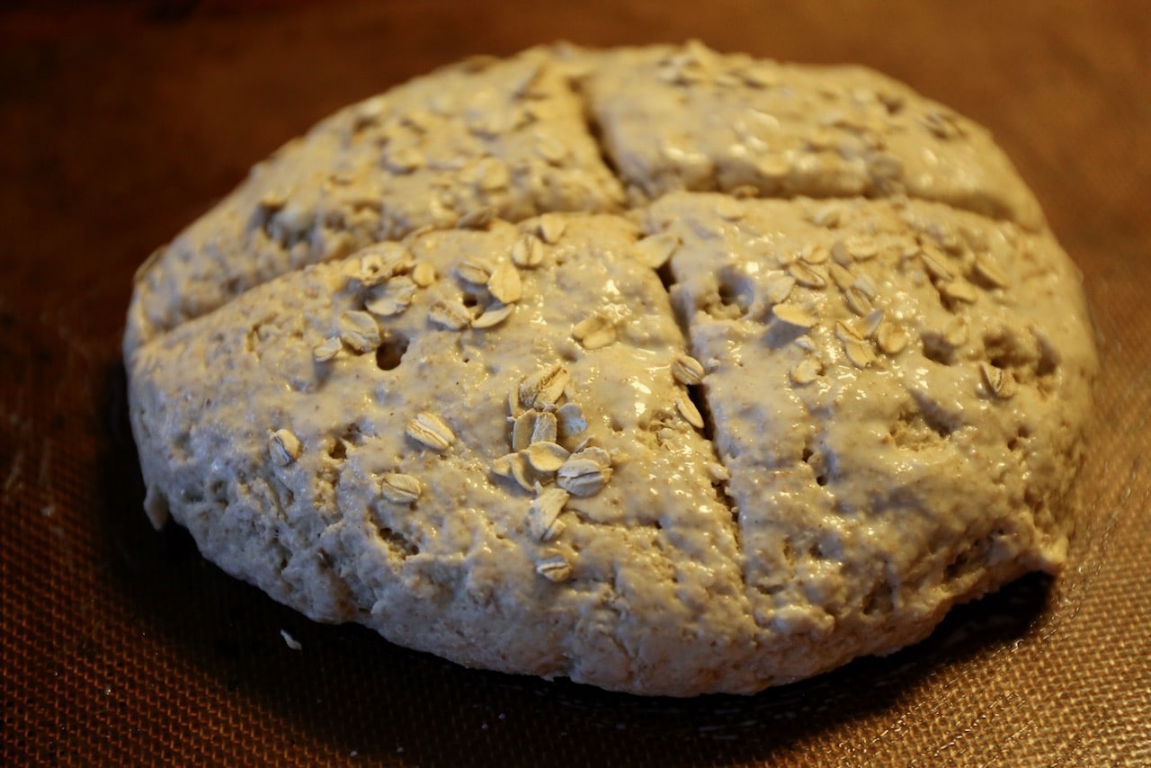 Score the loaf, brush with milk and sprinkle with oats before baking.
