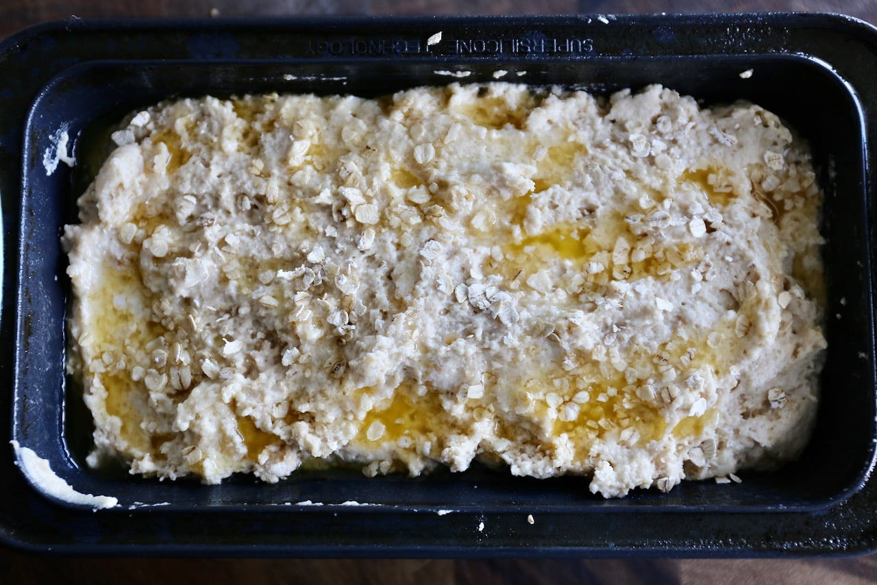Drizzle melted butter over bread dough and sprinkle with oats before baking.