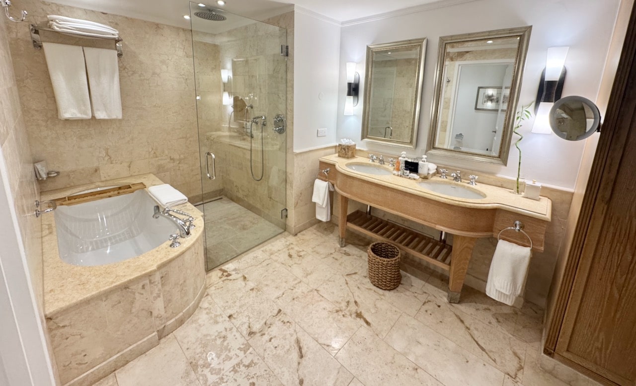 Marble-lined bathrooms feature rain showers and soaker tub.