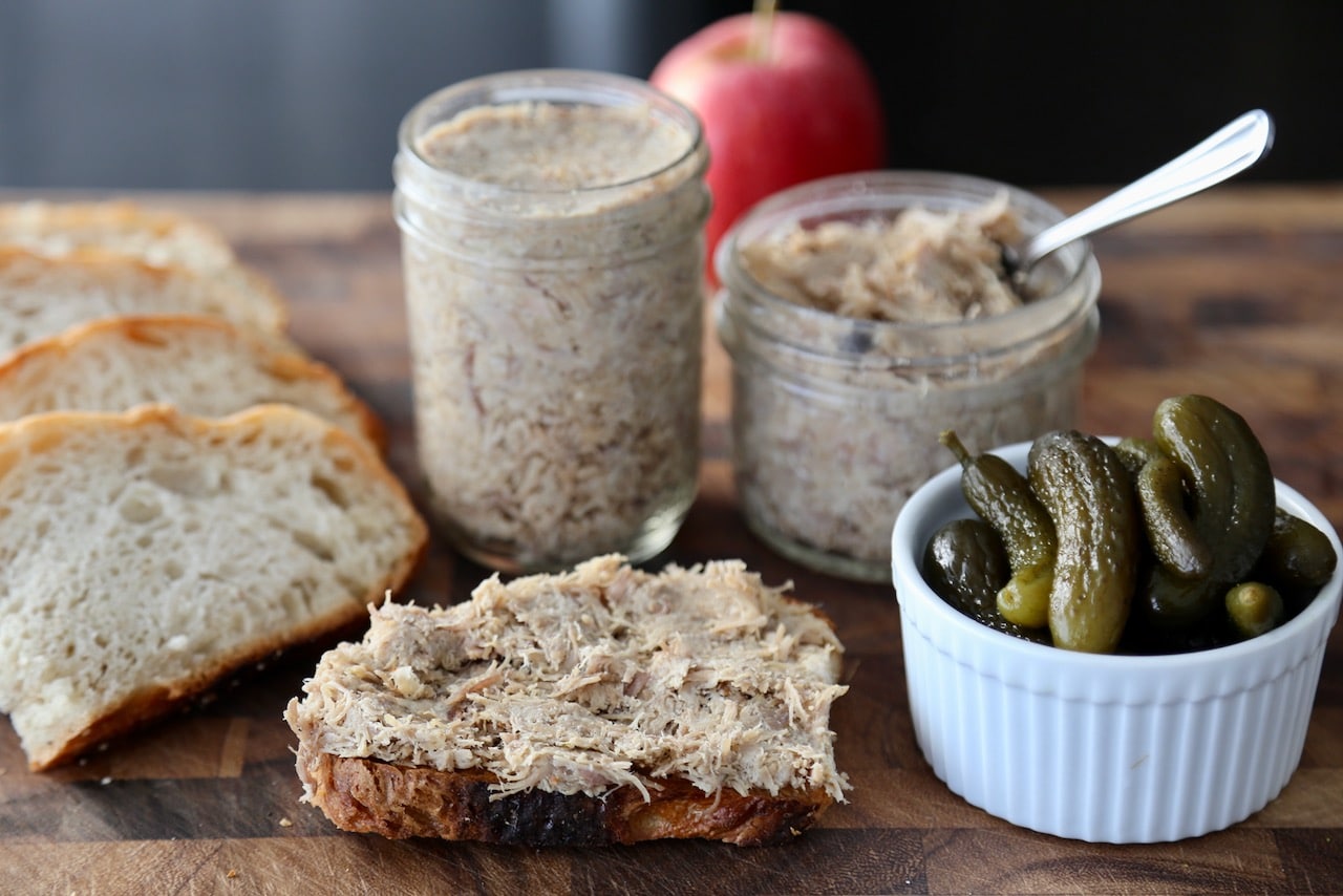 Spread Pork Rillettes on a slice of sourdough bread or baguette for a simple snack.